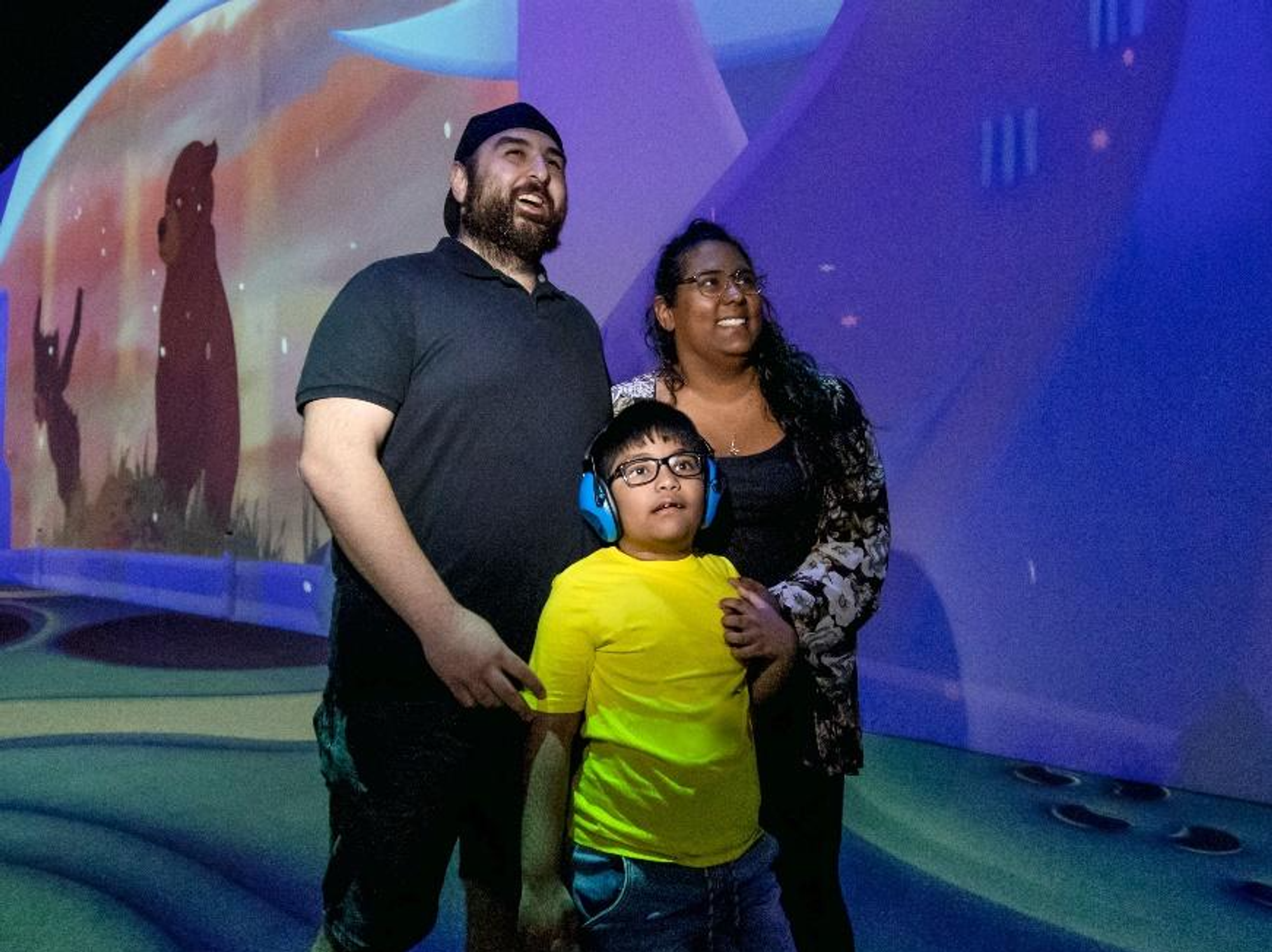 A family enjoys a Disney Immersive Experience show together