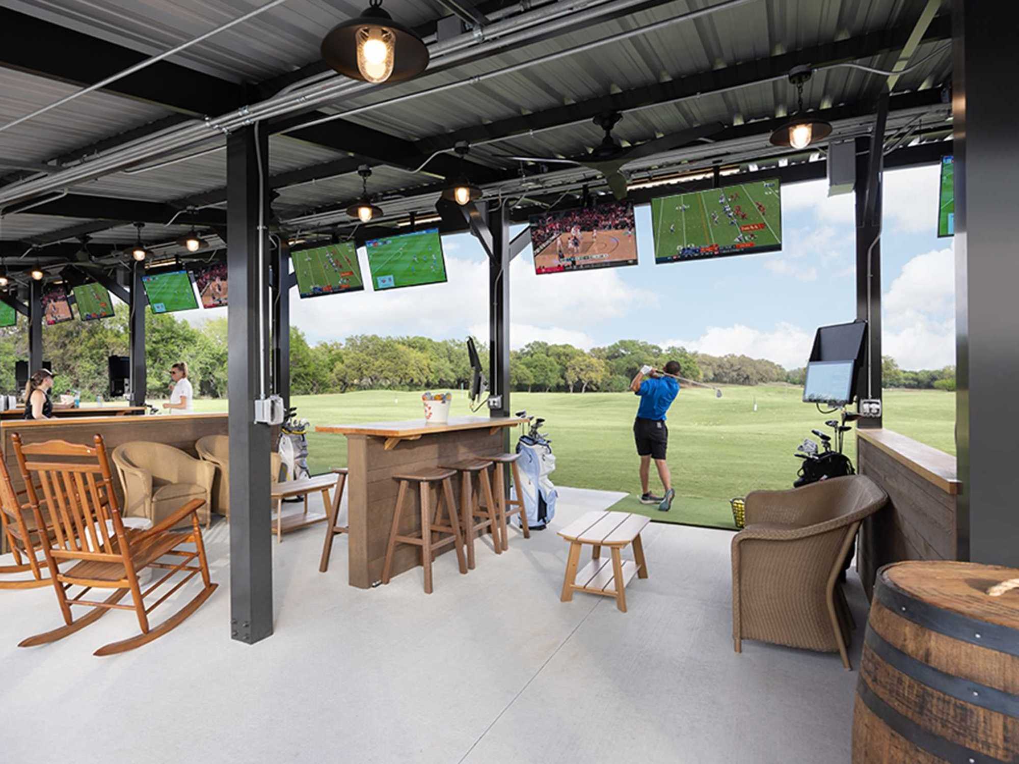 A folfer at the Hill Country Golf Club uses one of the Toptracer Range golf bays
