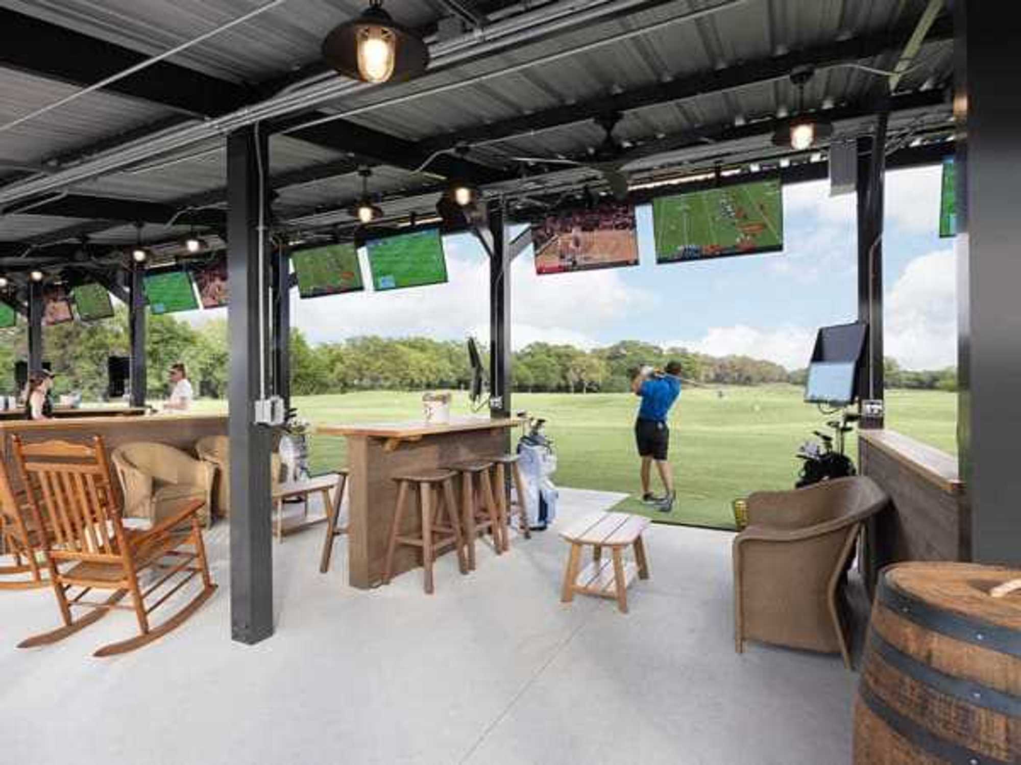 A folfer at the Hill Country Golf Club uses one of the Toptracer Range golf bays