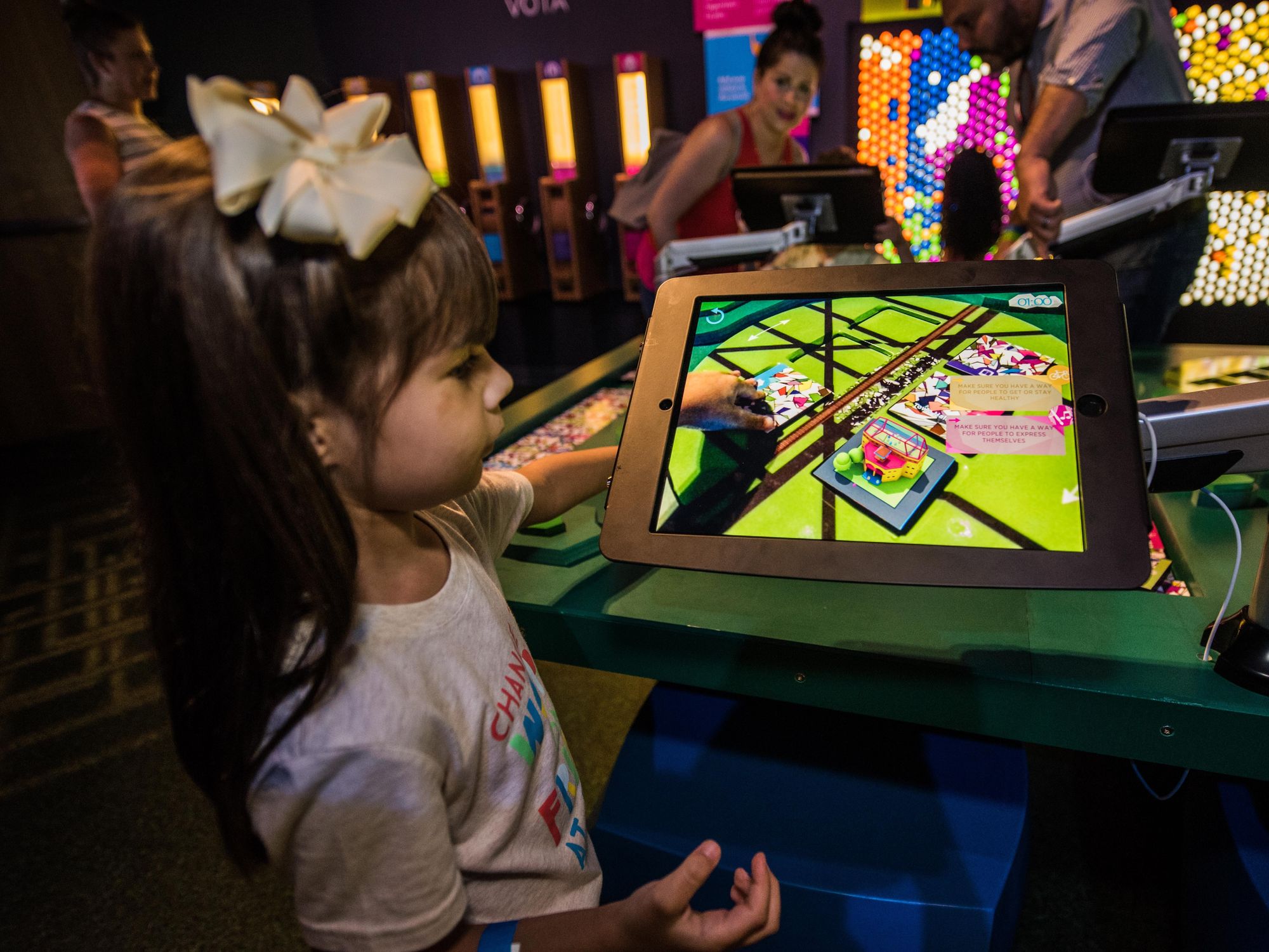 A girl interacting with a museum exhibit. 