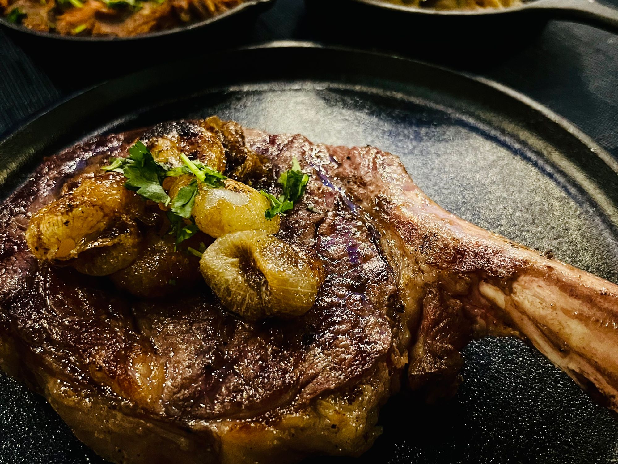 A Mesquite Smoked & Grilled Texas Akaushi Cowboy Bone-In Ribeye Steak at Ambler