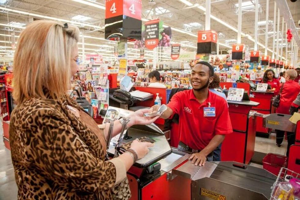 An H-E-B worker checks out a shopper