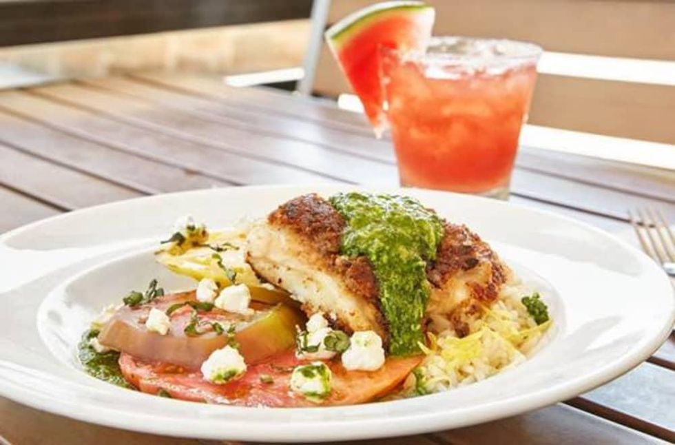 "Kalamata Crusted Alaskan Halibut with almond basil pesto, heirloom tomatoes with goat cheese and lemon-scented rice" by Fish City Grill.