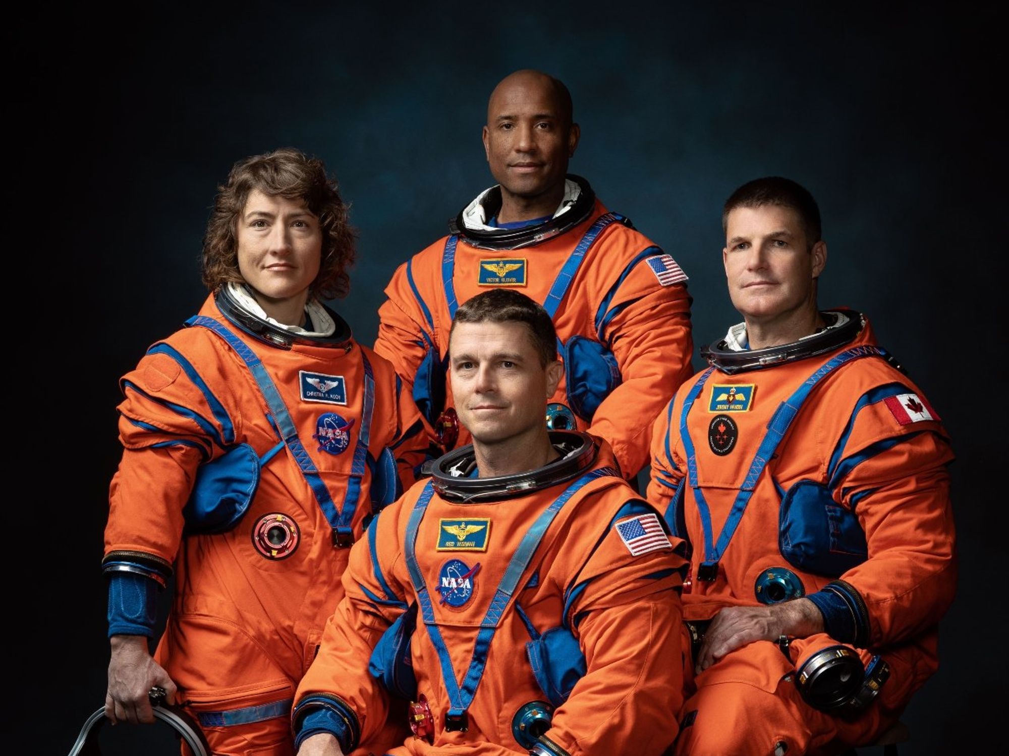 NASA Artemis II mission astronauts Christina Hammock Koch, Reid Wiseman (seated), Victor Glover, and Canadian Space Agency astronaut Jeremy Hansen.