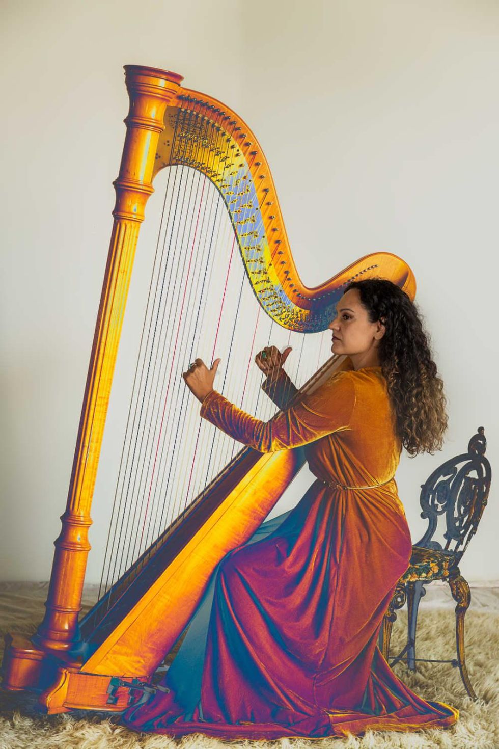 Pamela Martinez plays the harp.