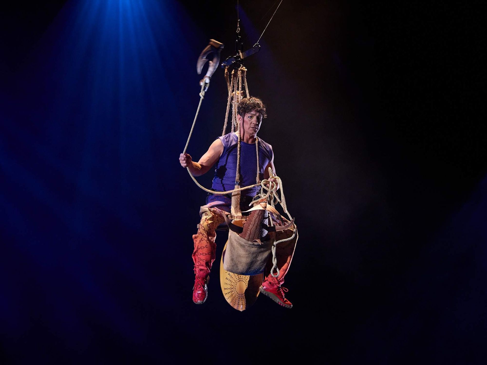 Salvador “Sal” Salangsang on a wire harness in Cirque du Soleil