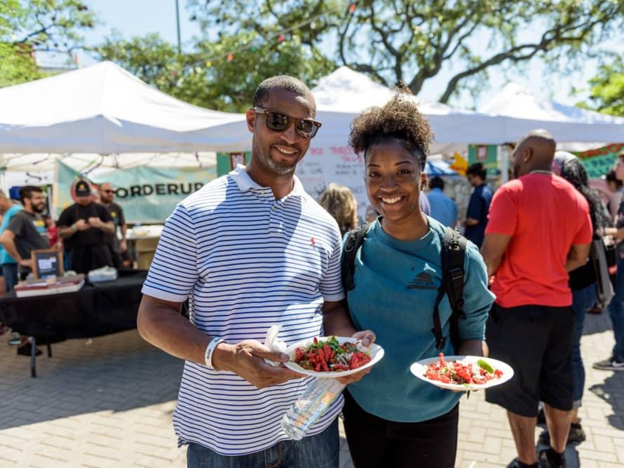 Taco fest couple holding tacos