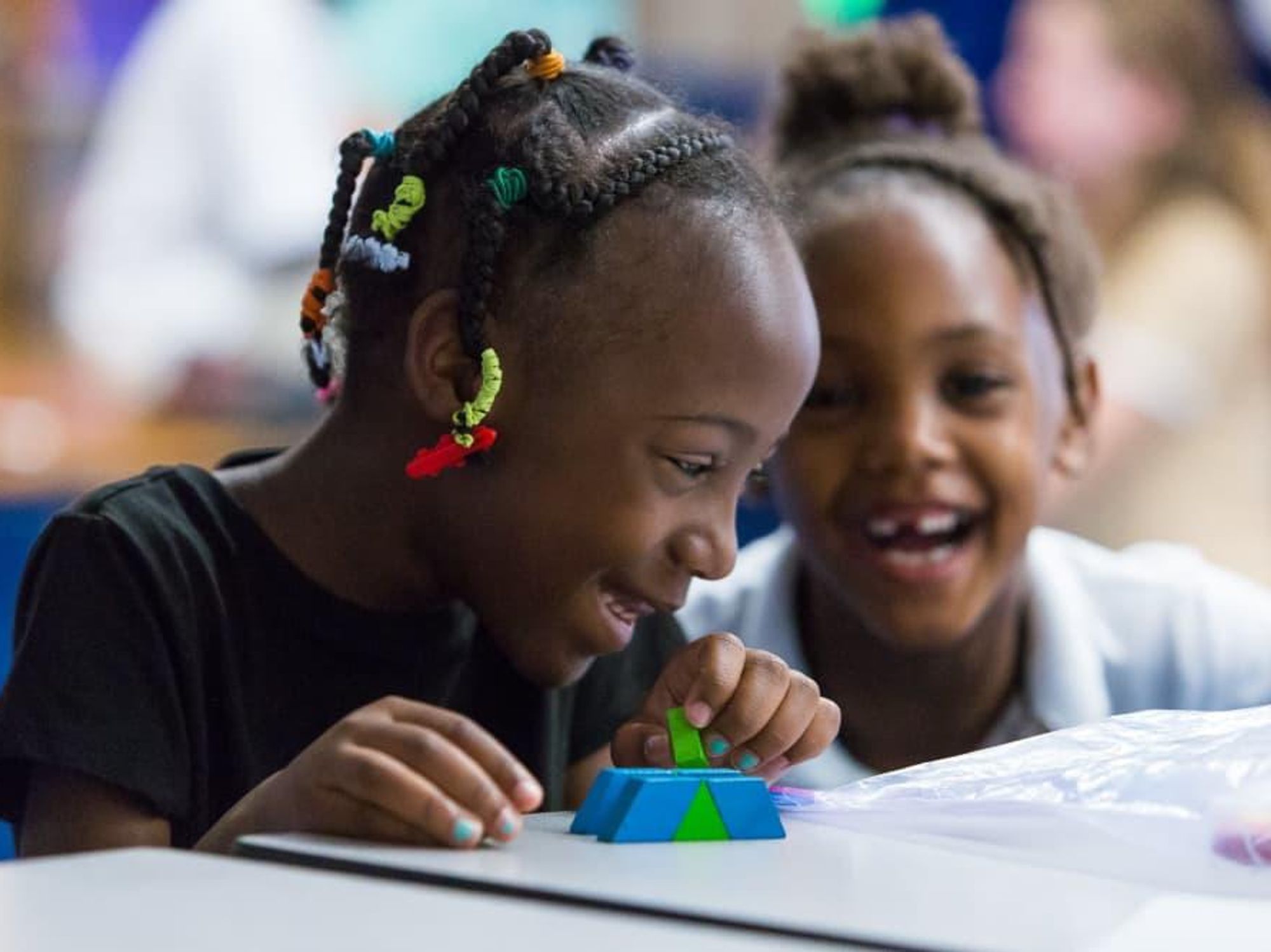 Two little girls playing with blocks