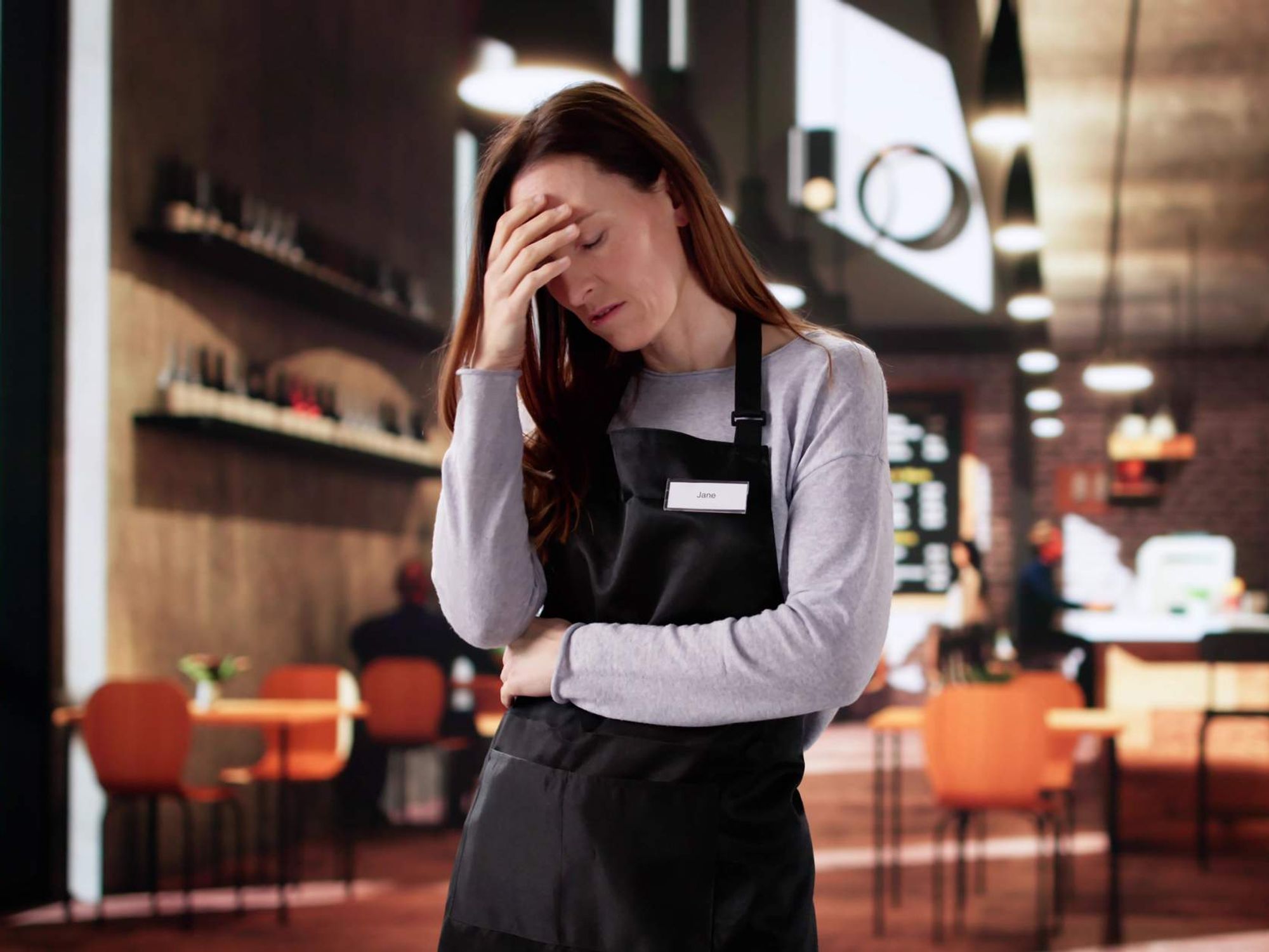Unhappy woman reading report at cafe feeling stressed