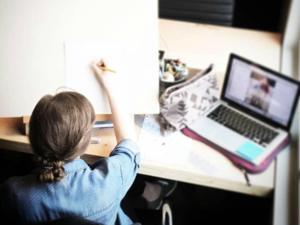 Woman working and drawing at desk with computer